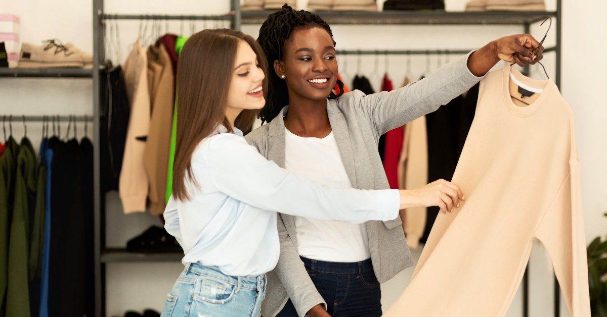fashion stylist assists a client in selecting designer clothing.