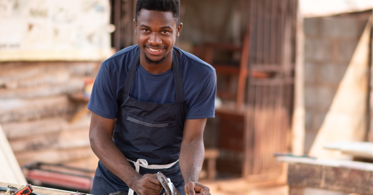 young afircan carpenter smiling