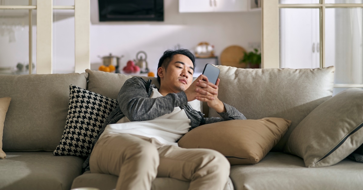 Man reading his phone on couch