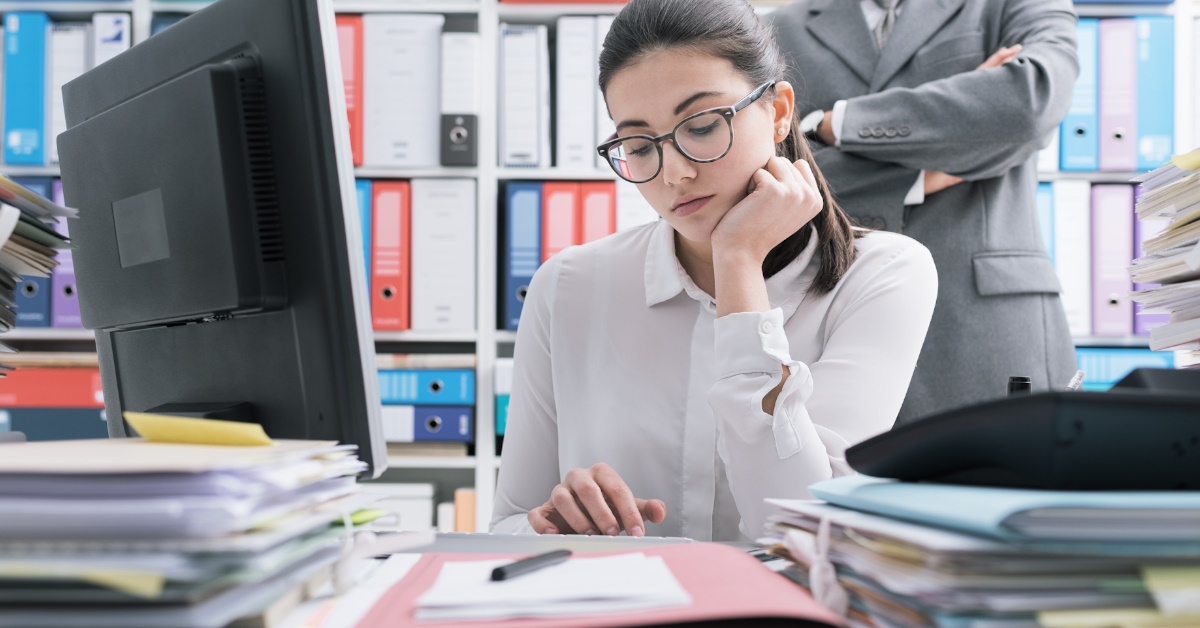 Boss watching over female employee