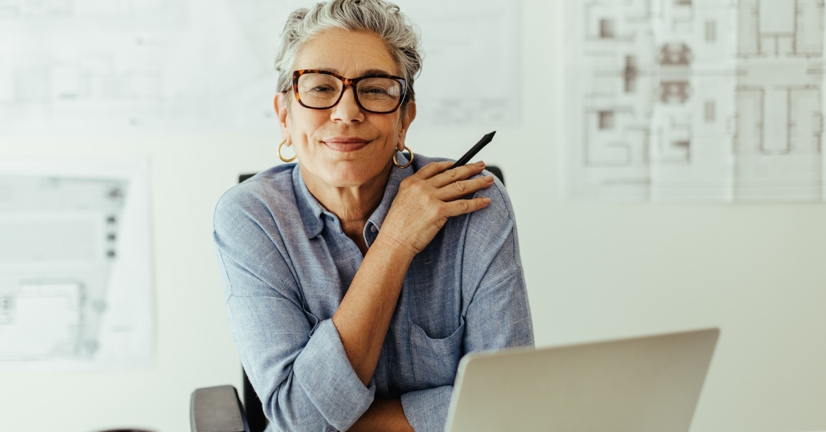 Confident female designer posing at work