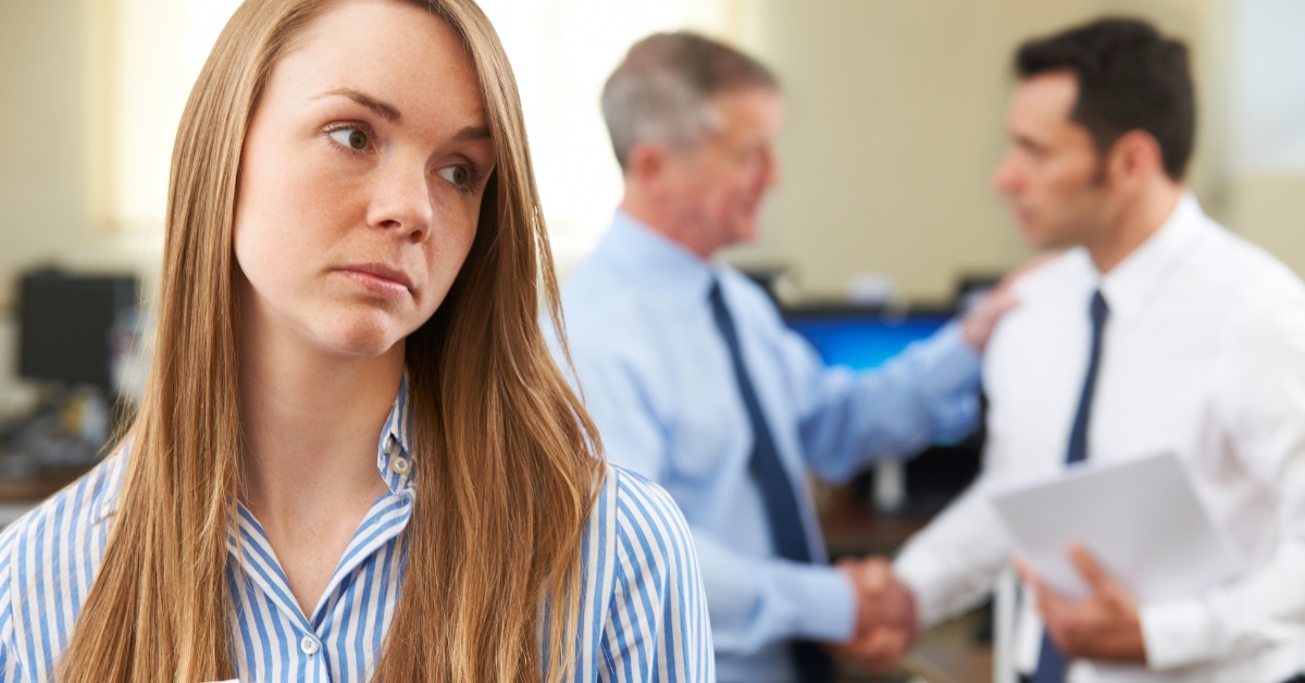 Unhappy woman with happy colleagues