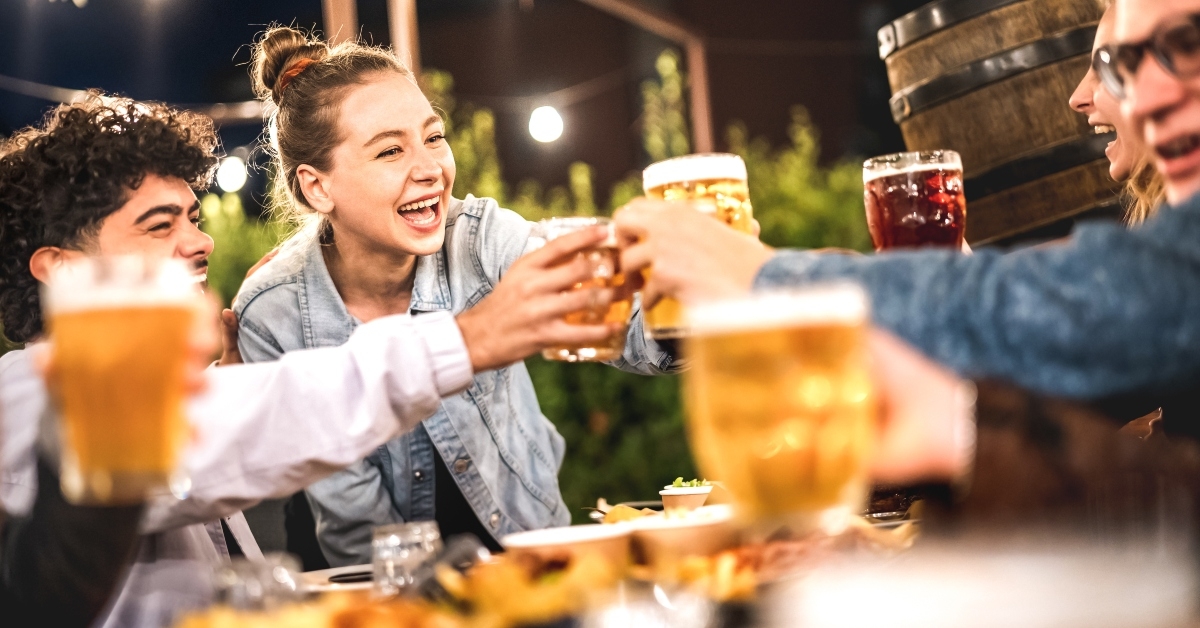 Happy friends toasting beer