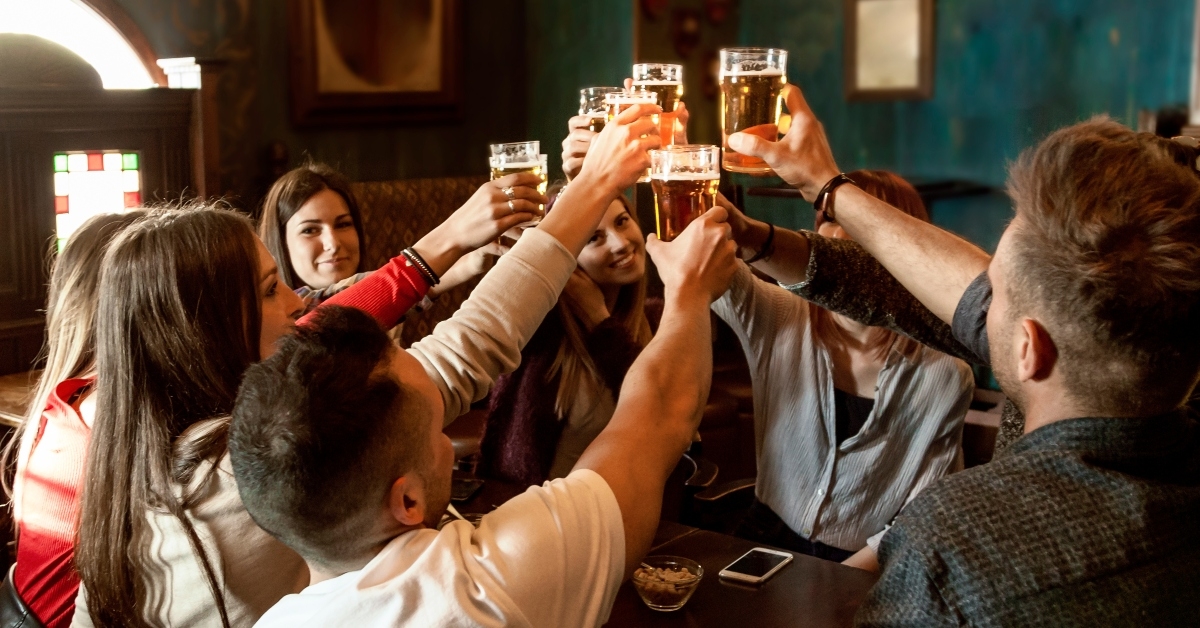group of people celebrating in a pub
