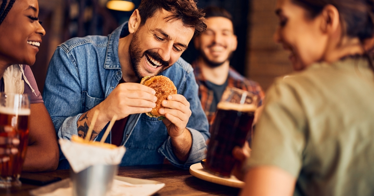 happy man eats burger