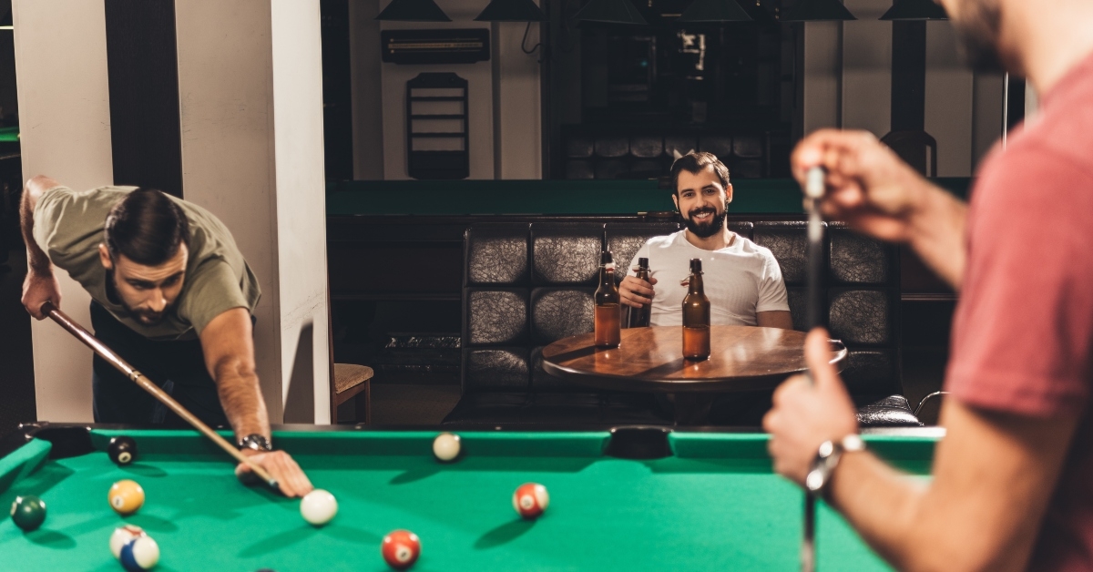 men playing in pool at bar