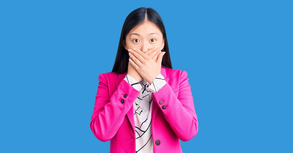 woman shocked covering mouth with hands