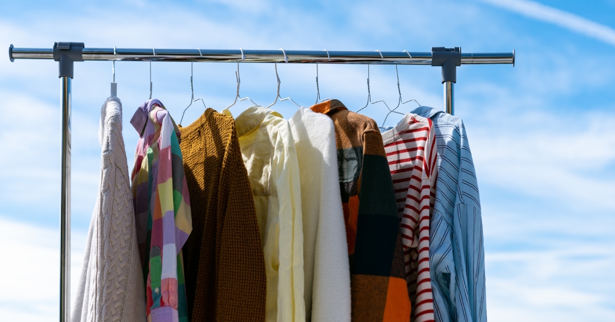 clothes hanging on rail outside