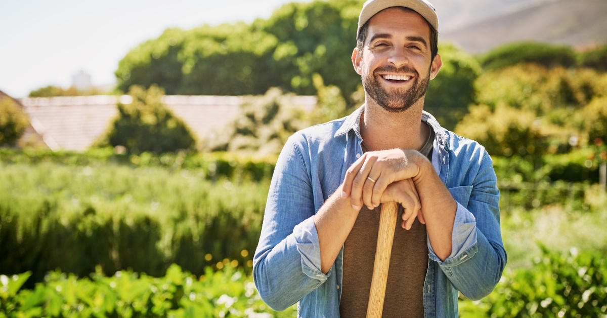young male farmer standing in field