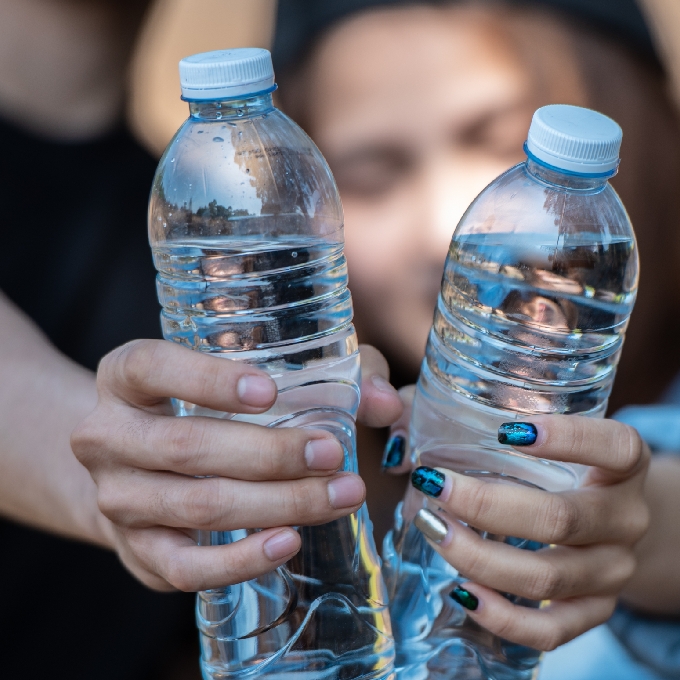 people holding drinking water bottle