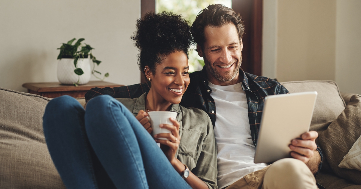 couple on a couch with tablet