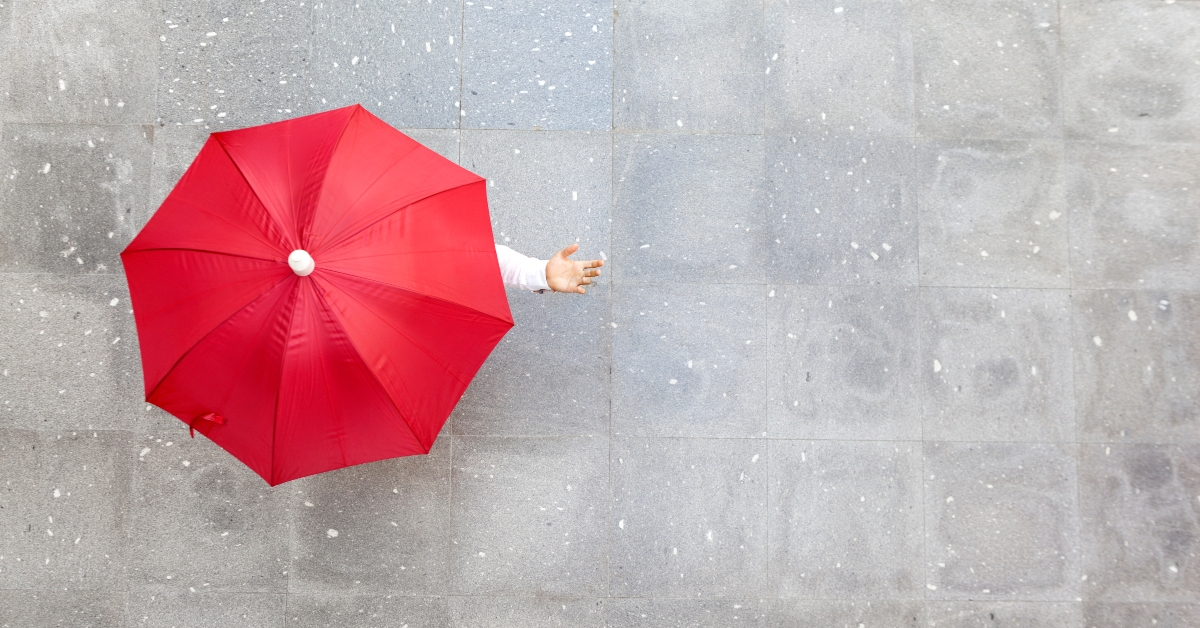 man holding a red umbrella