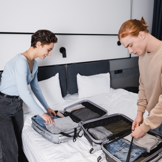 A couple packing their suitcases