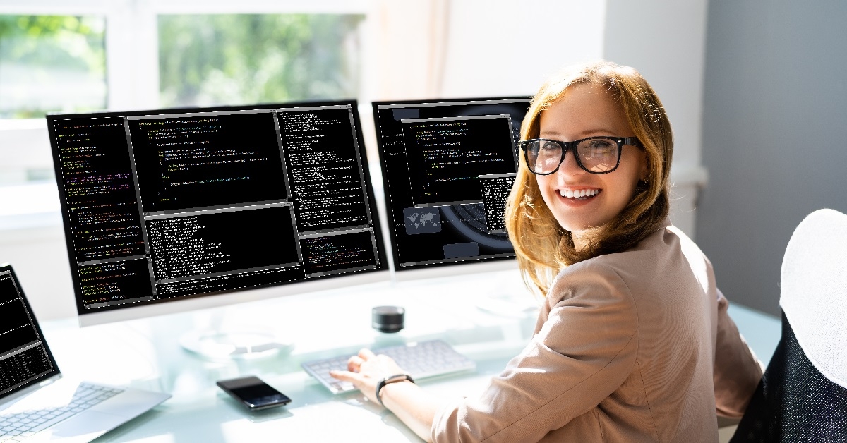 happy woman coding on computer