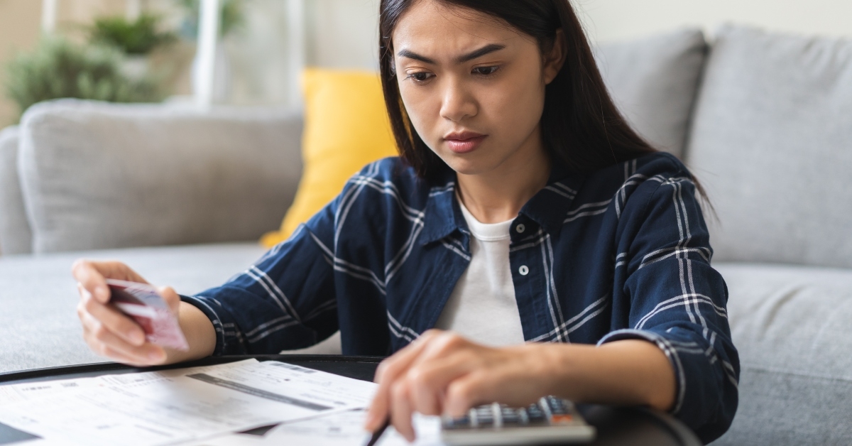 Woman looking at bills