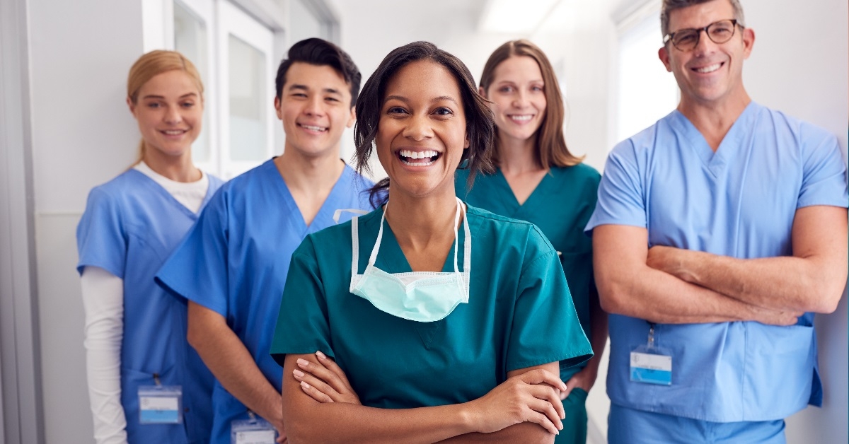 Happy doctors standing in hospital corridor