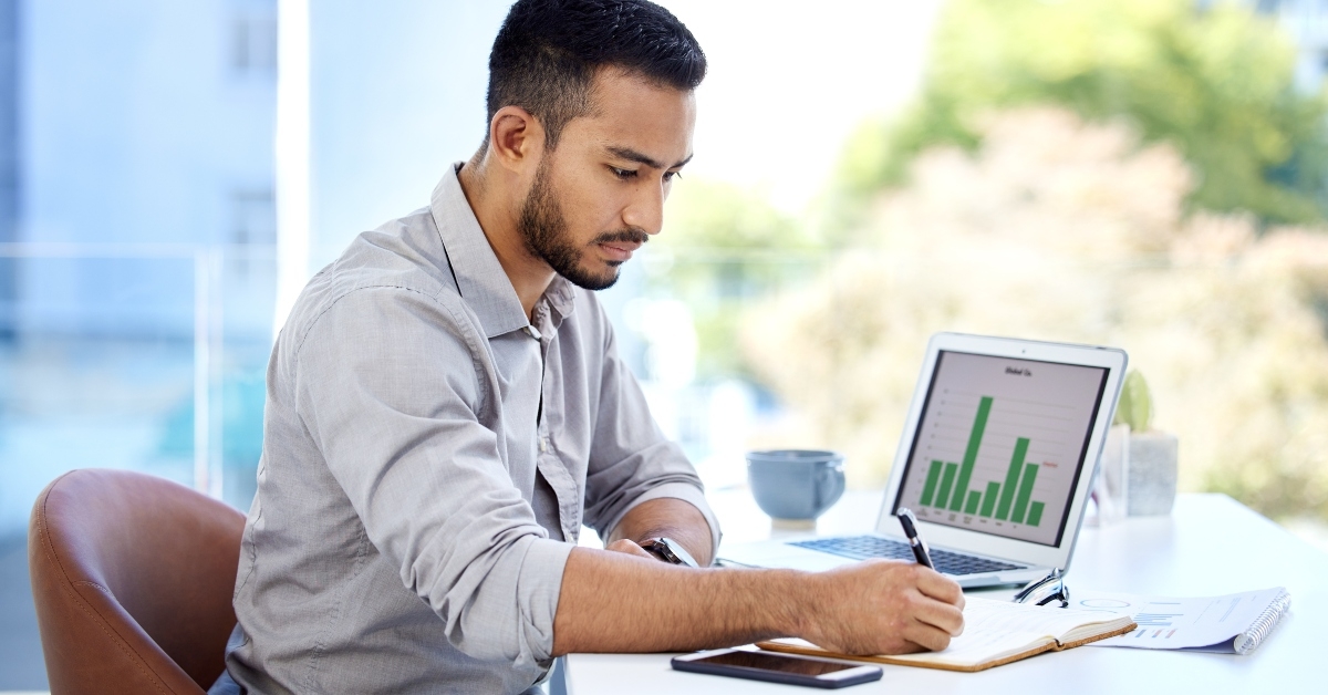 Man looking at investing graphs