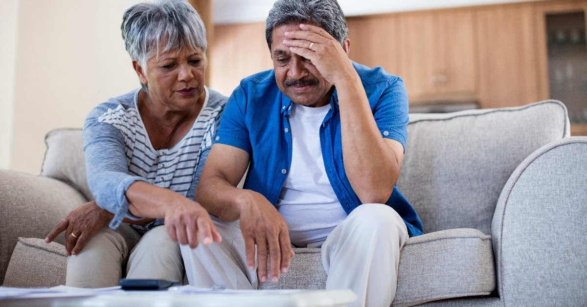 senior couple stressing while reviewing bills