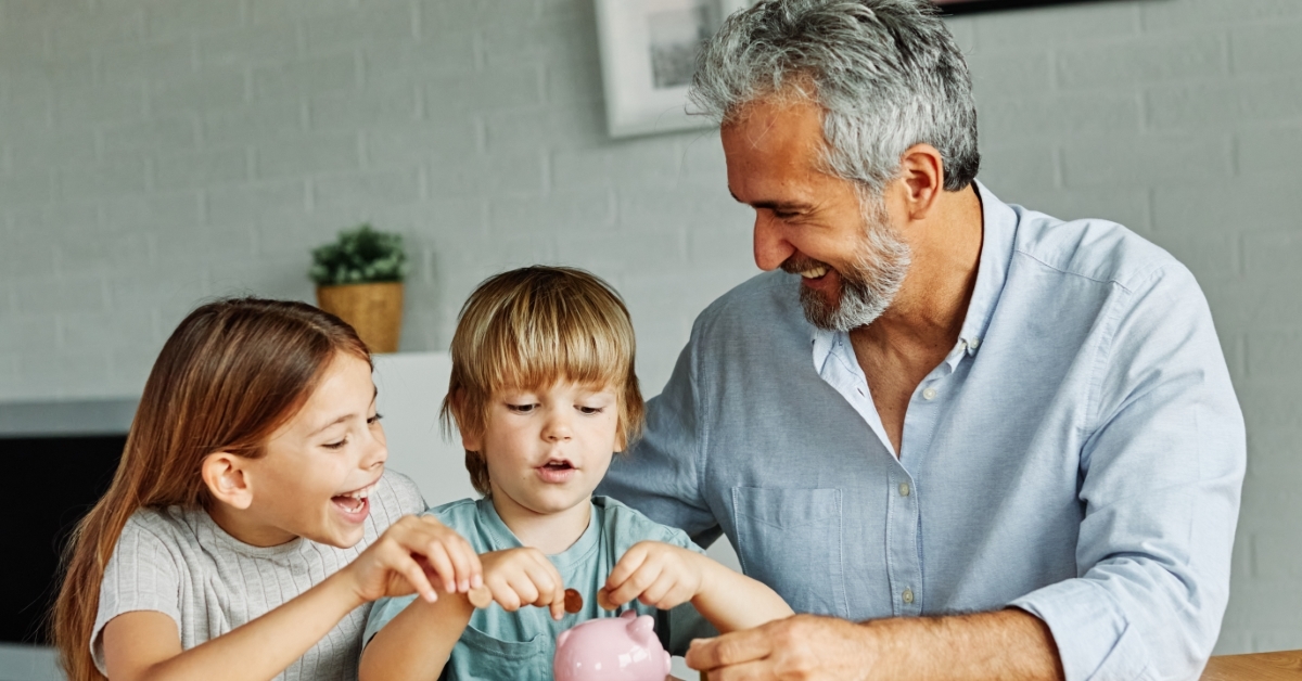 A grandparent teaching his grandkids how to save