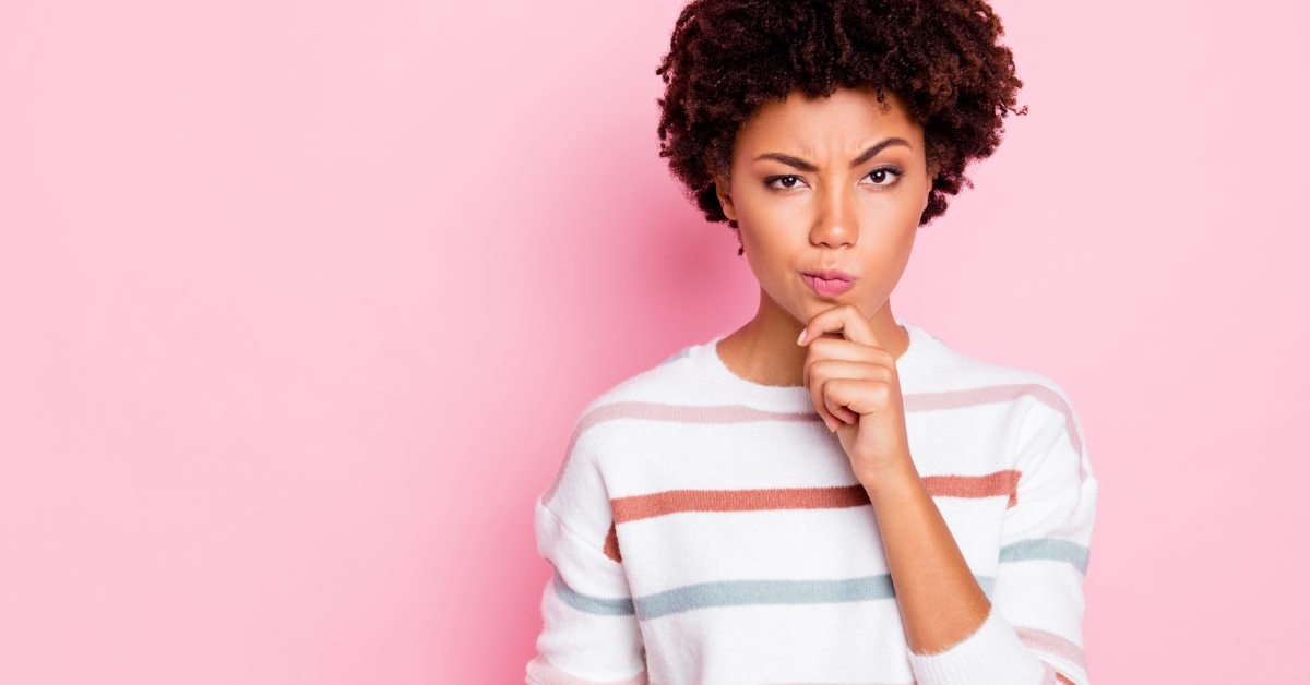 Woman raising eyebrows in confusion