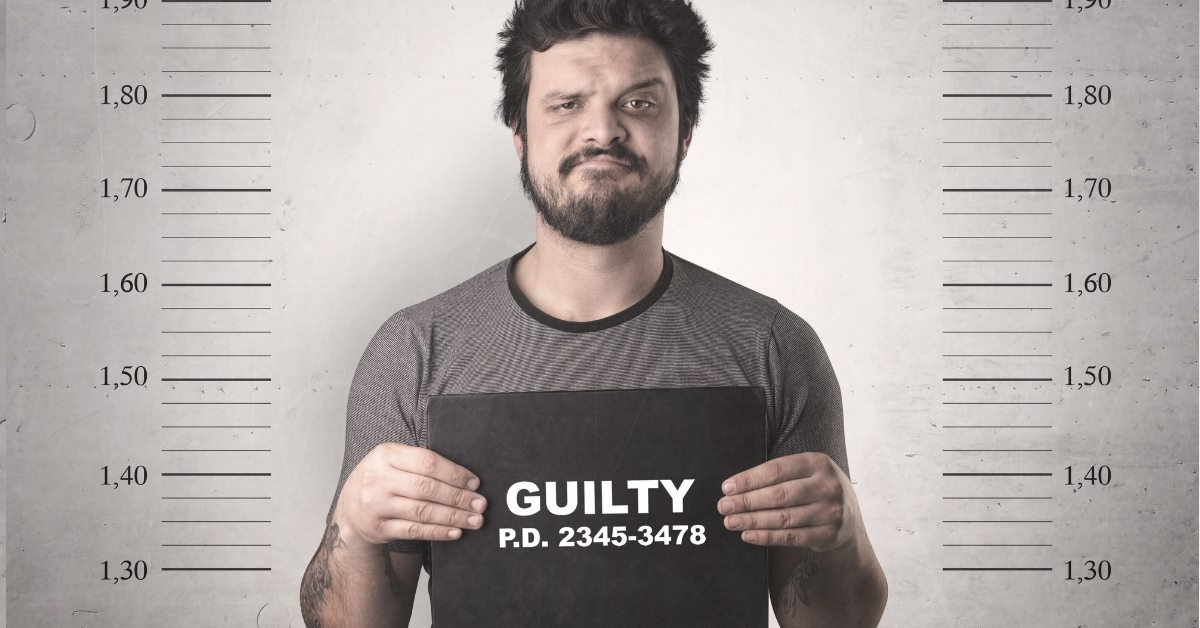 Someone holding a guilty sign