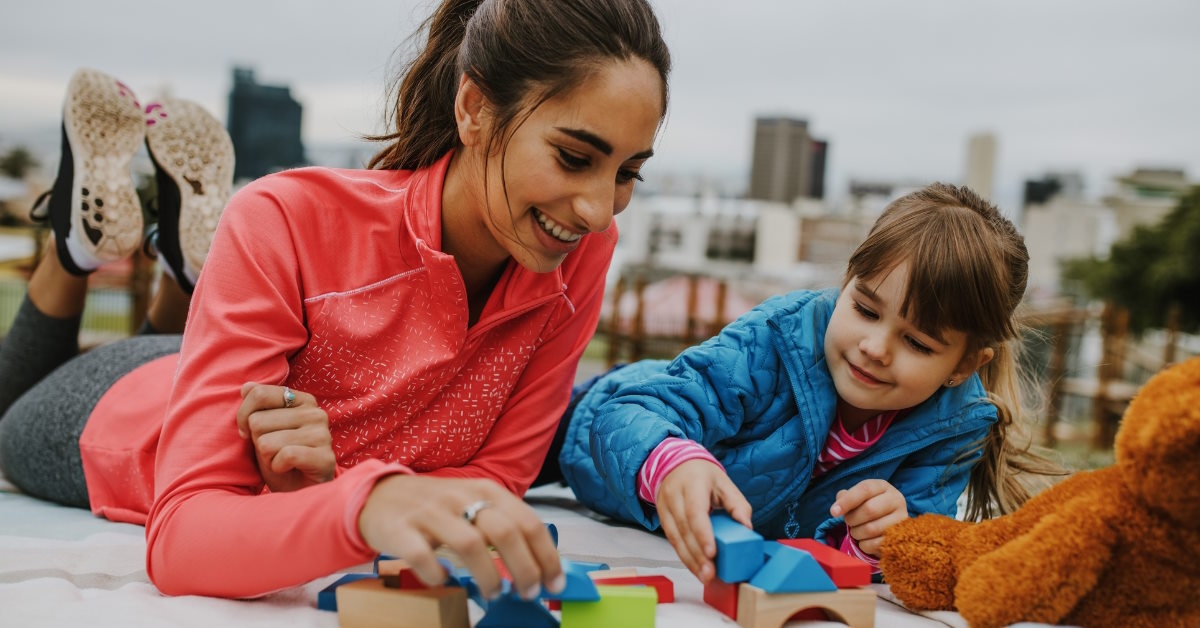 young girl playing with nanny outdoor