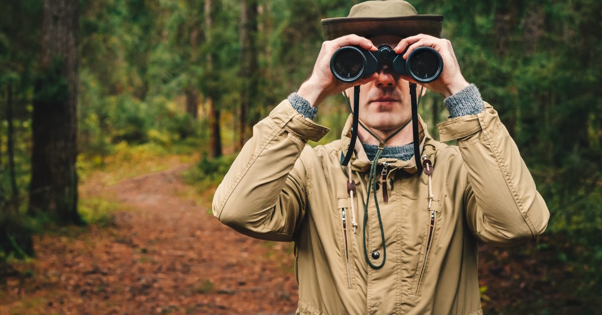 explorer watching territory using binoculars
