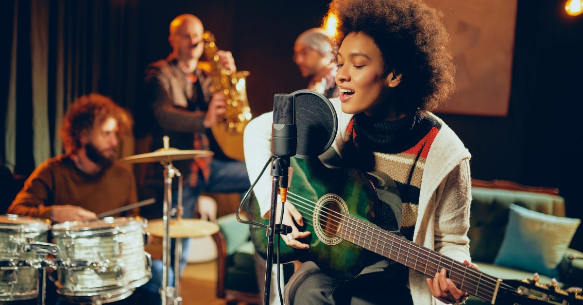 woman singing and playing guitar