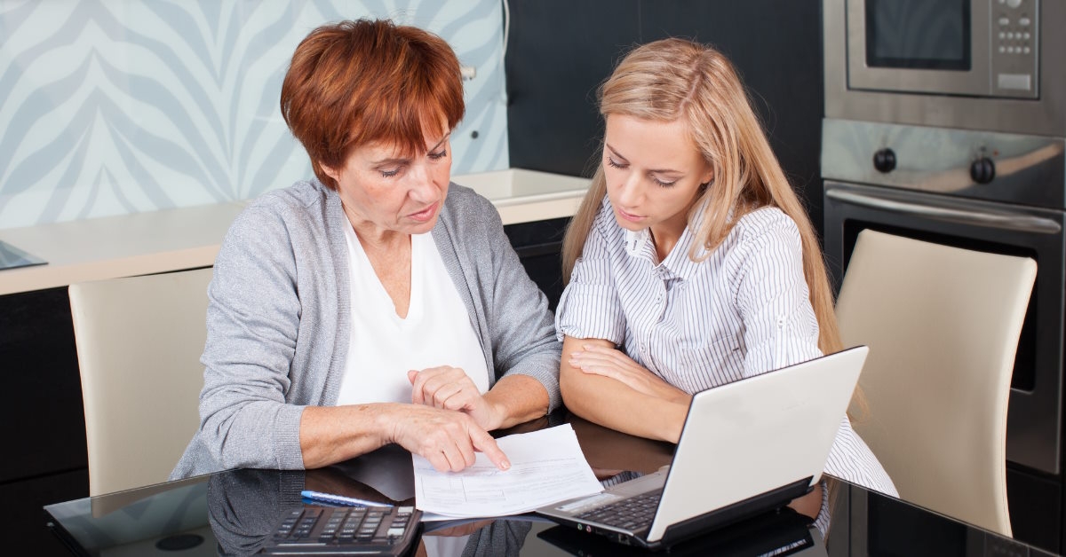 two women reviewing documents at home