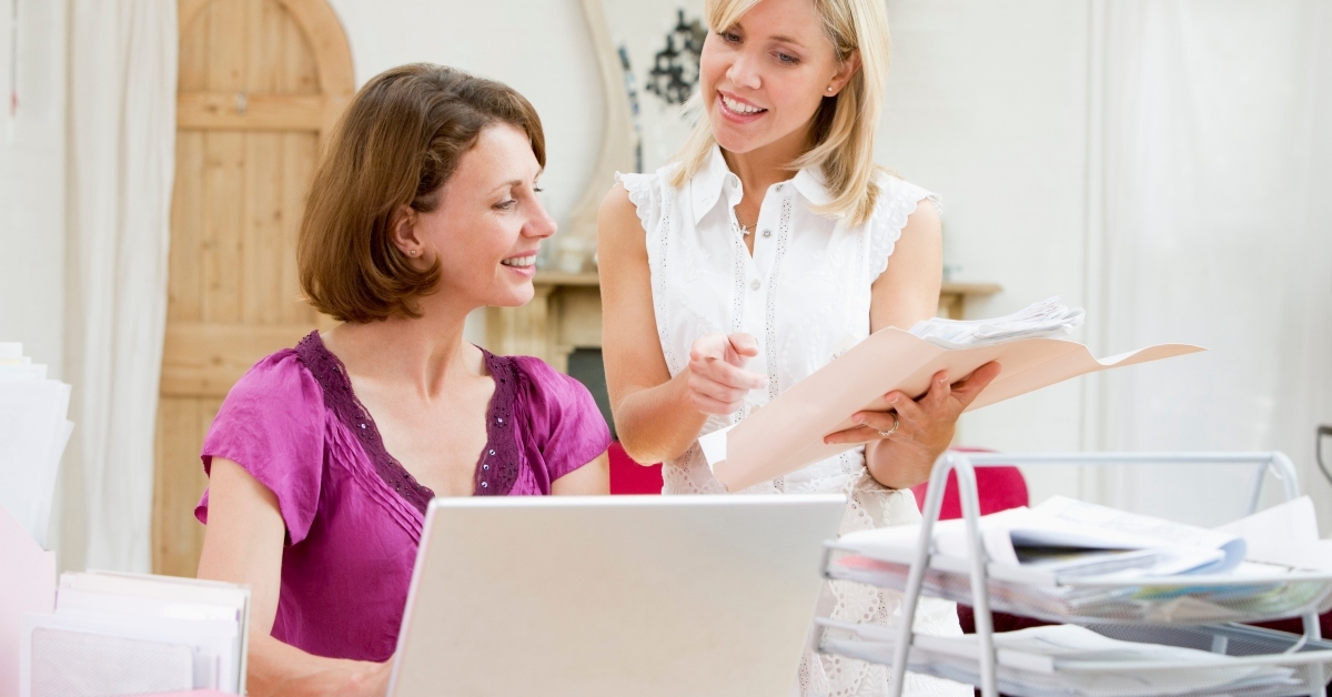 women looking at paperwork
