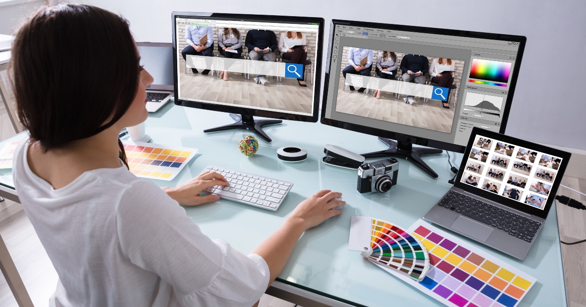 female designer working on multiple computer