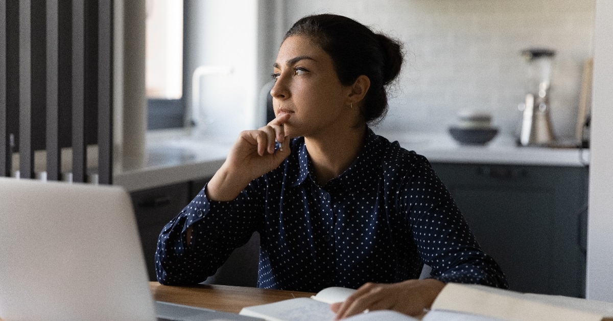Woman jotting down notes in a notebook