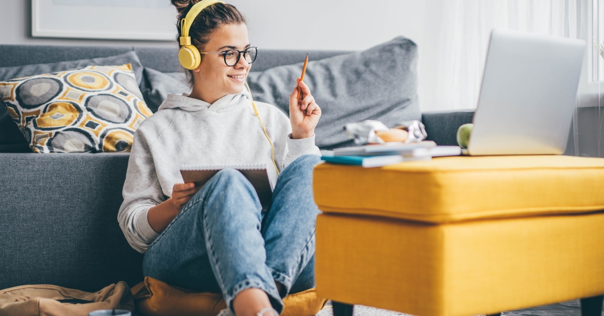 Happy woman studying on laptop