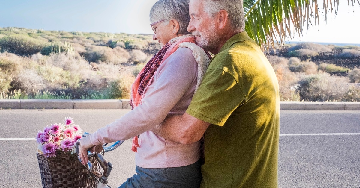 Elderly couple riding on a bike