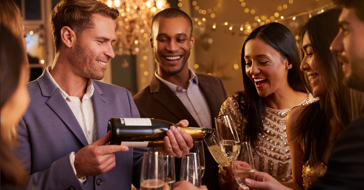 Man pouring champagne for friends