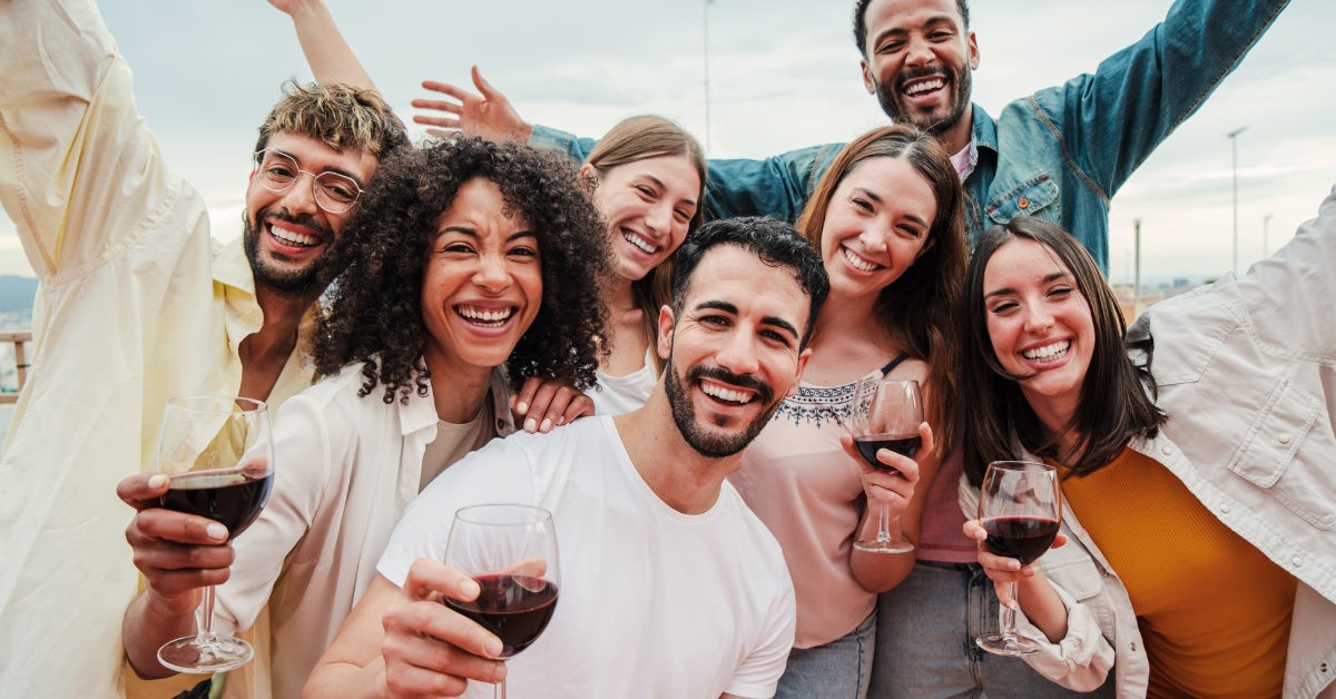 Group of happy friends toasting wine