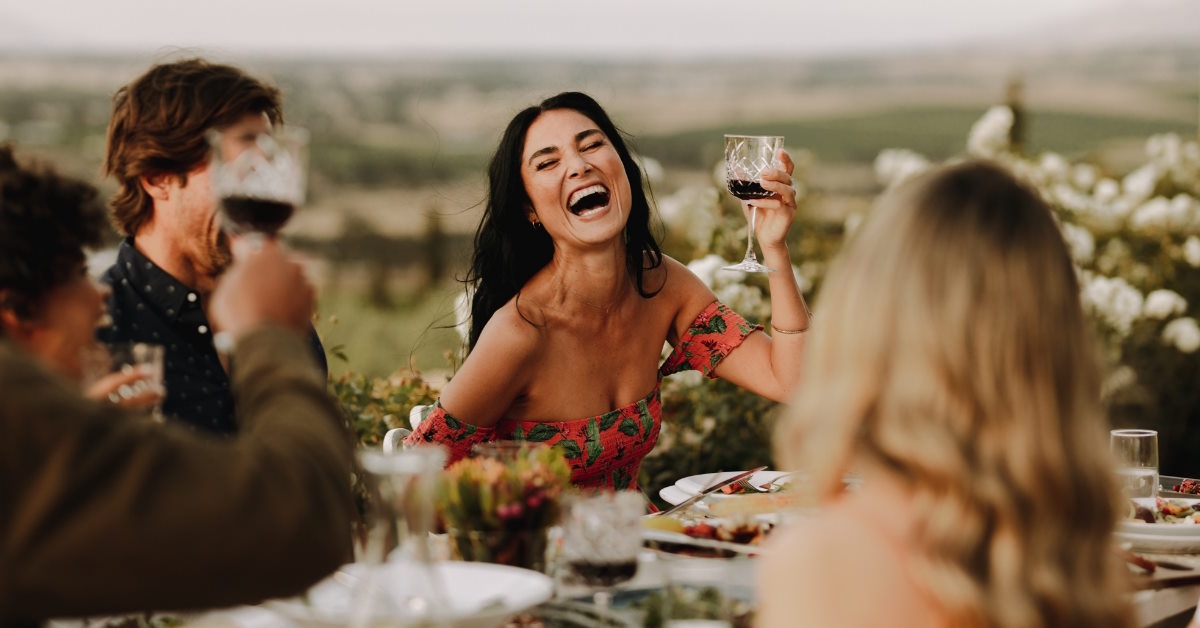 Happy woman at dinner with friends