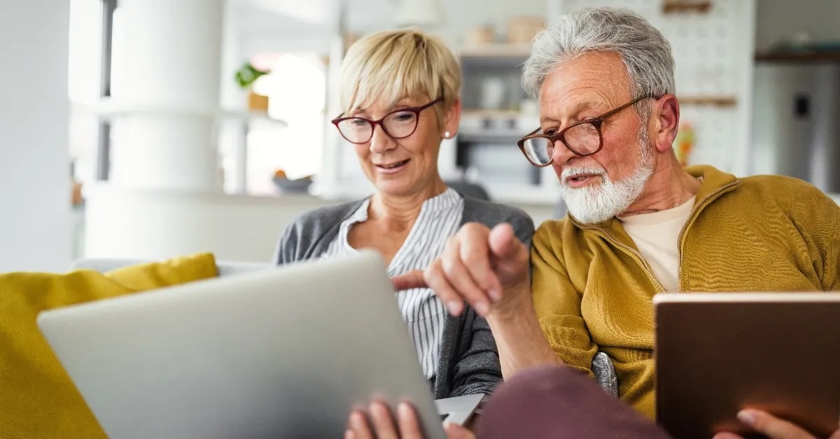 senior couple using laptop
