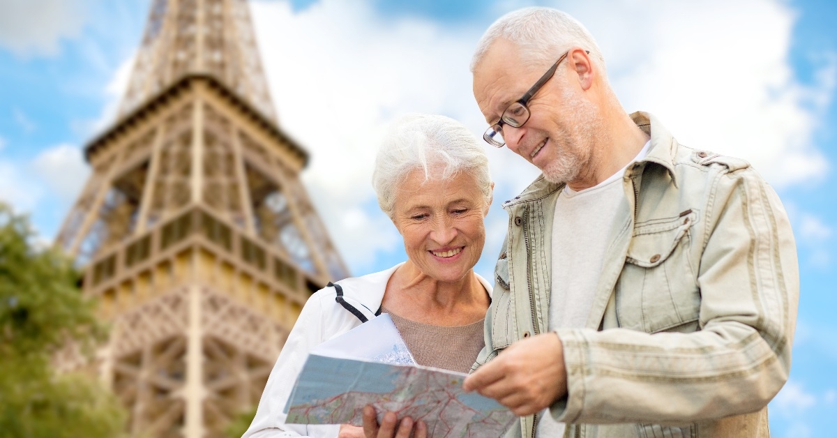 Elderly couple examining a map on city street.