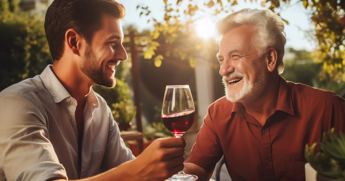Father and son enjoying red wine 