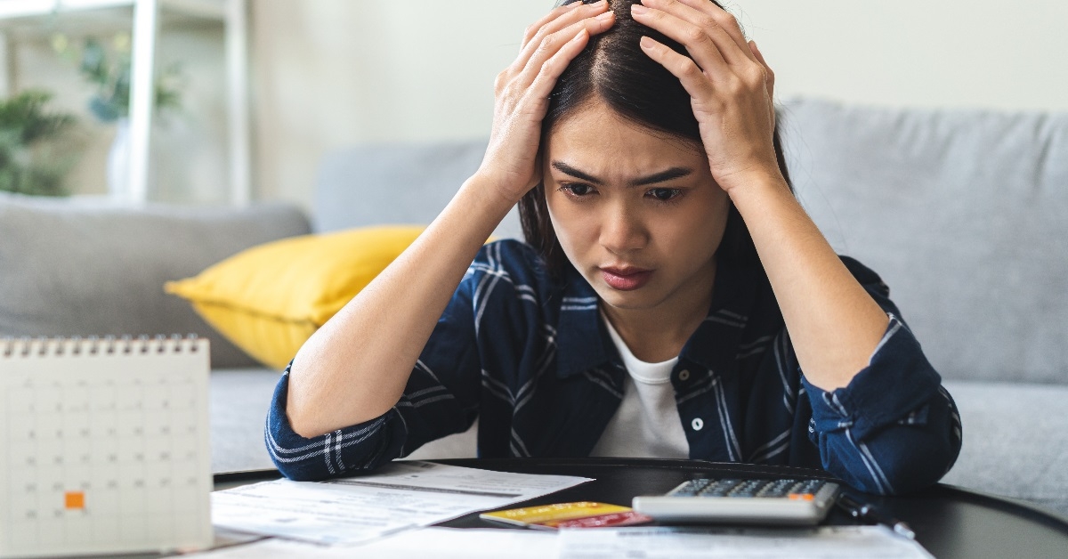 Woried woman calculating expenses