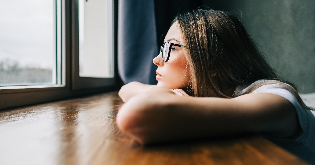 Bored woman gazes out of the window