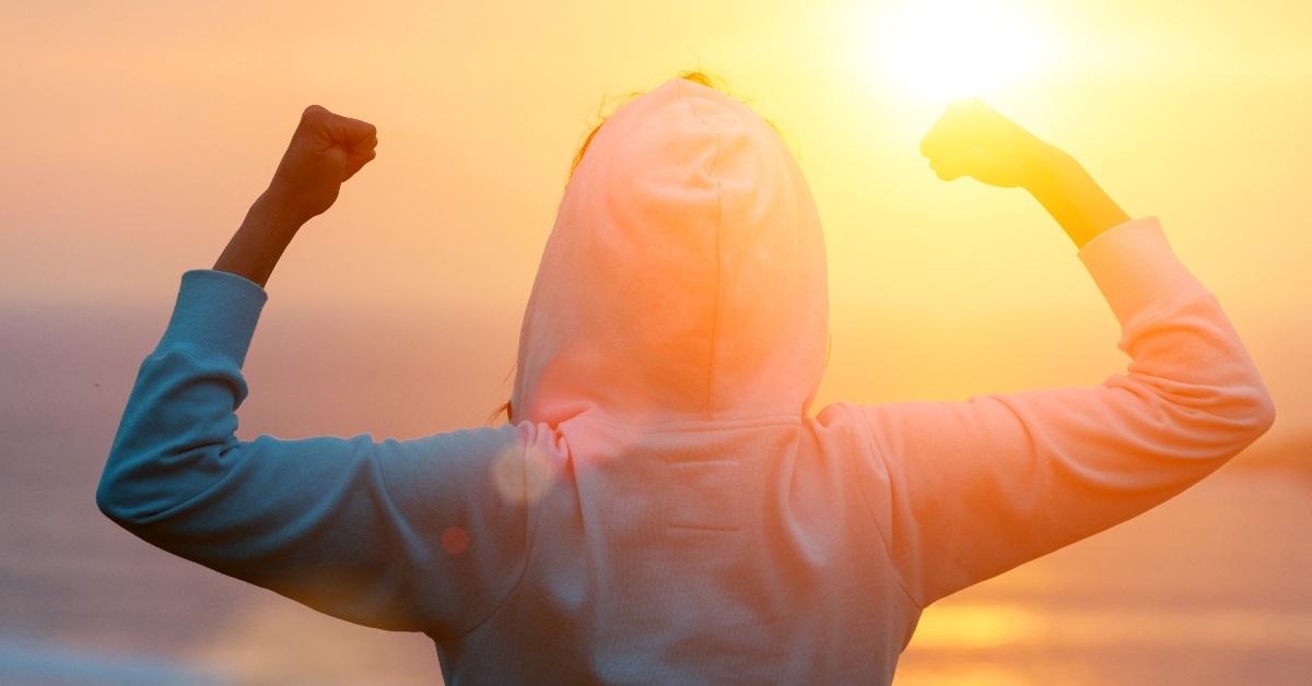 Woman celebrates reaching her goal