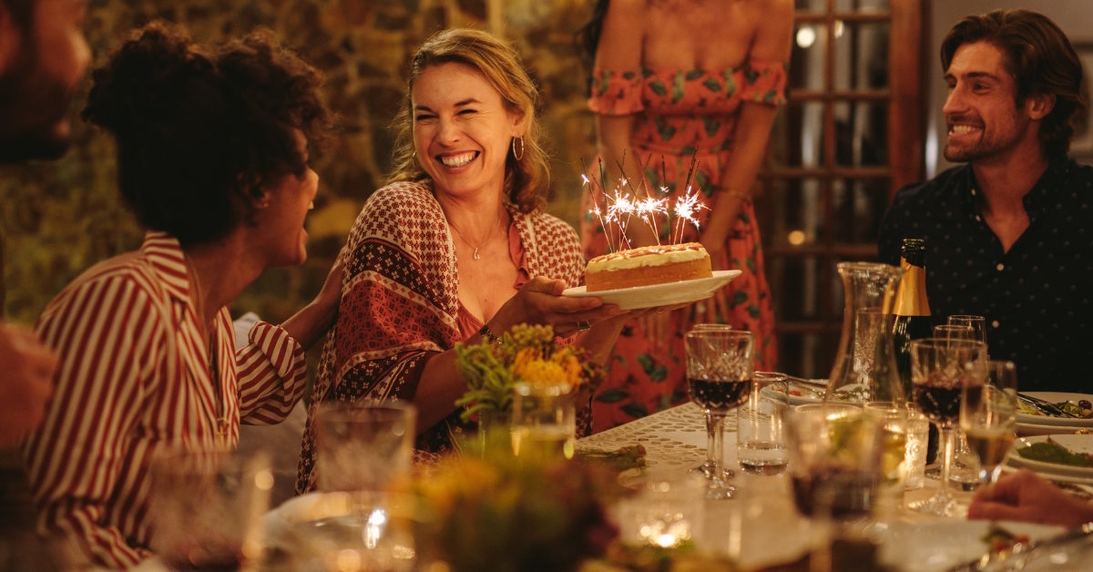 happy woman celebrating birthday with friends