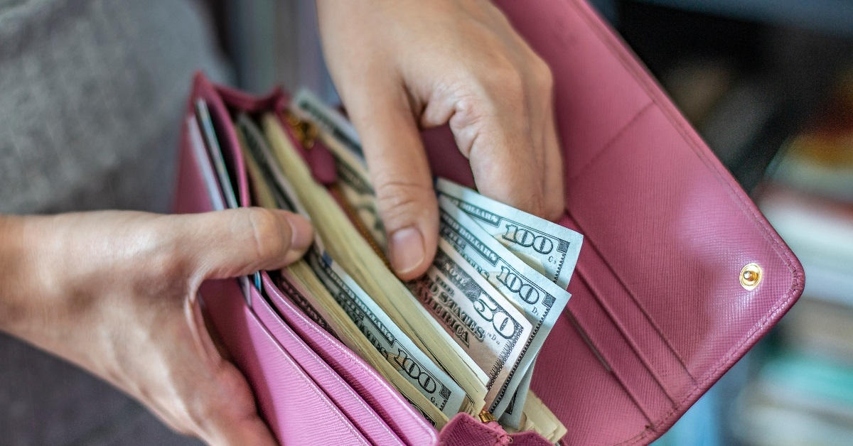 Woman taking money from wallet