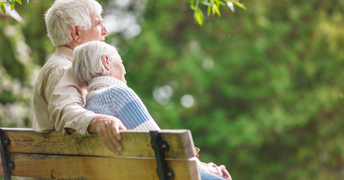 elderly couple resting on a bench