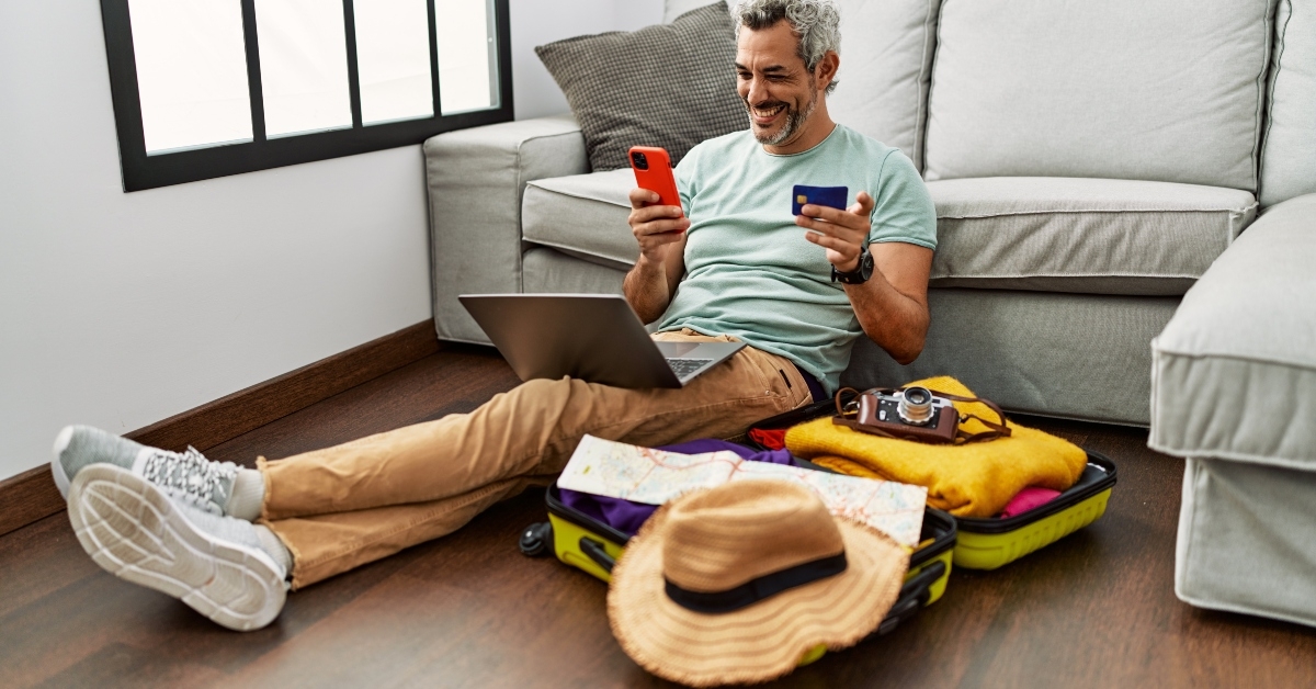 man using smartphone and laptop