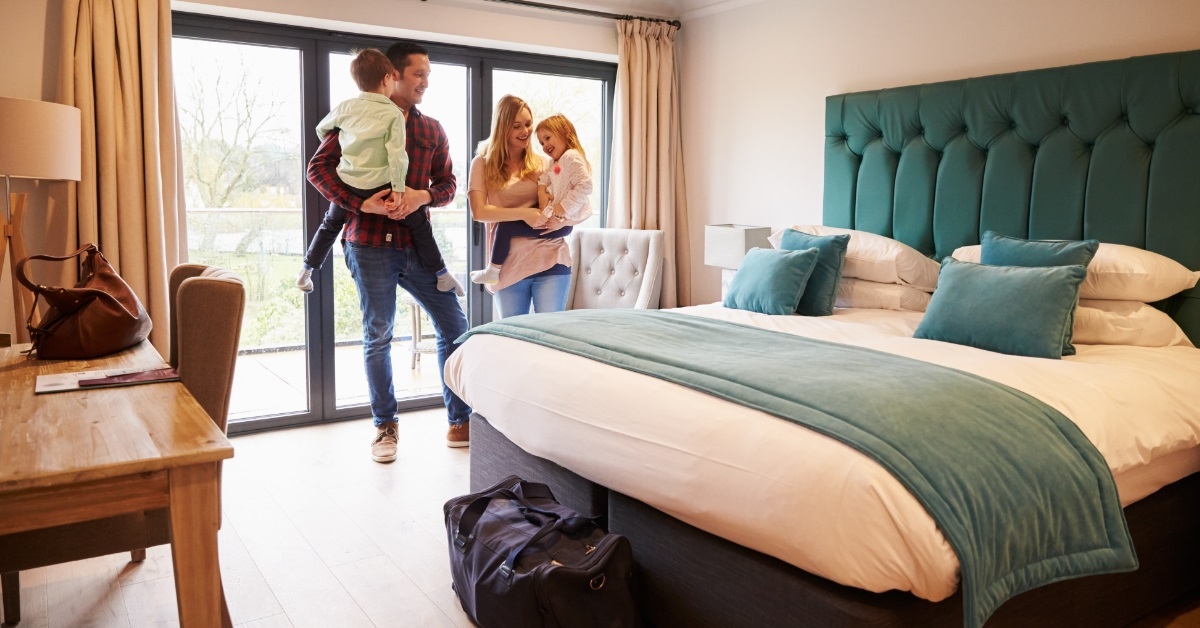 Family arriving at hotel room