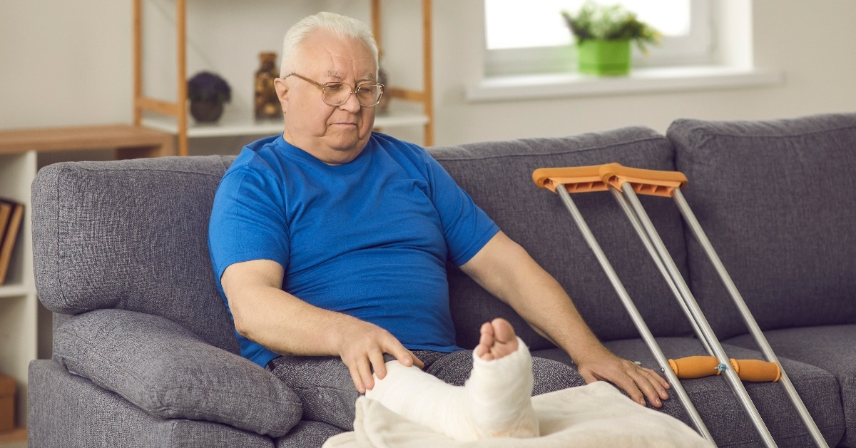 Man sitting on couch with a cast