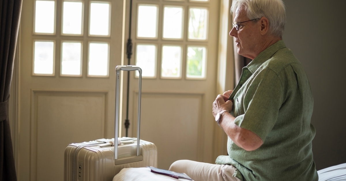 senior man packing luggage